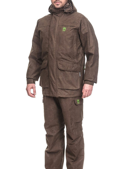 A person wears the WINTER SUIT ARGO® [JACKET + TROUSERS], ideal for hunting, against a white background. This Argo® outfit has multiple pockets, a small green logo, Velcro cuff straps, and a breathable waterproof membrane for all-condition comfort.